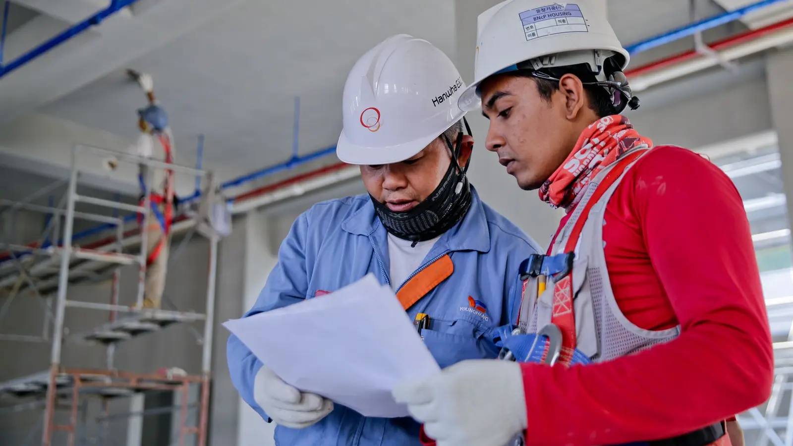 Engineering team reviewing project drawings at a construction site