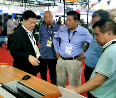 Technical discussion at the SICOMA exhibition stand
