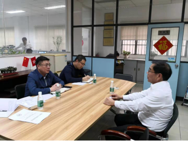 District officials discussing business operations with company representatives